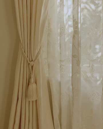 A craftsperson pressing custom drapery fabric.