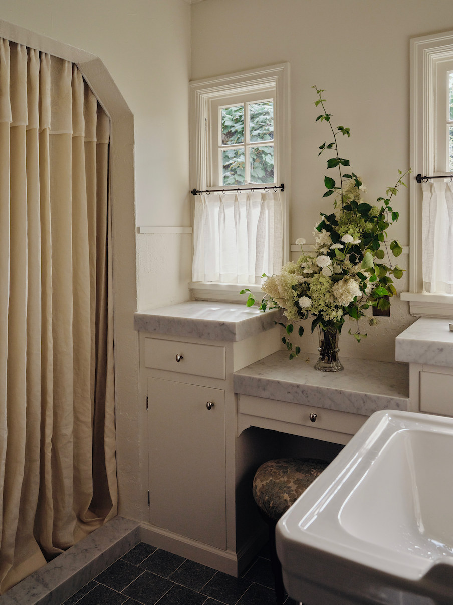 Layered drapery framing a softly lit window.