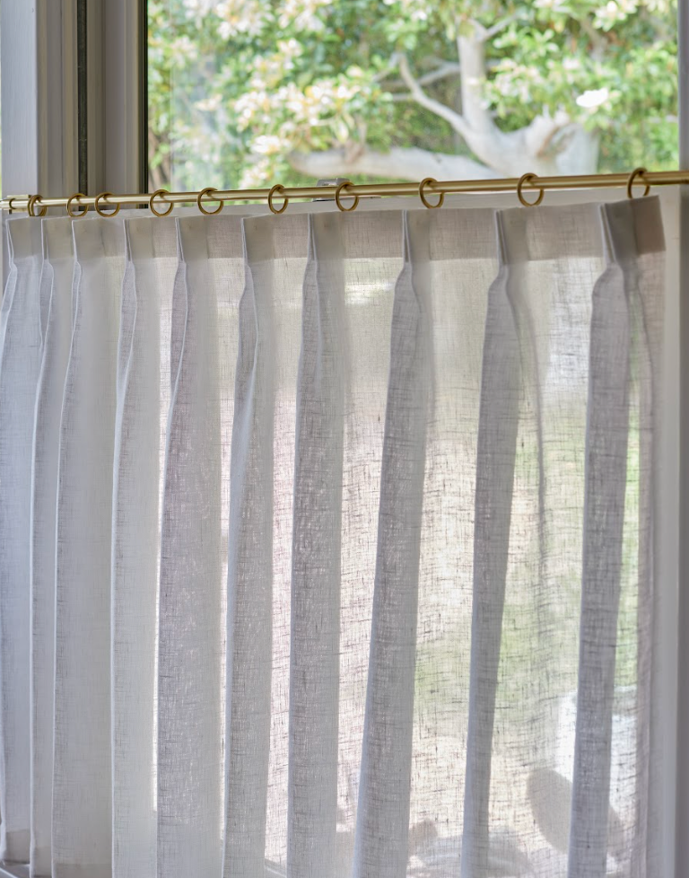 Unlined café curtains filtering daylight