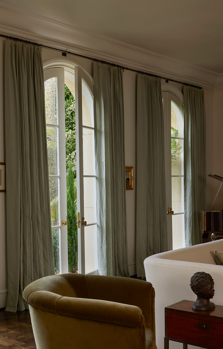 Four drapery panels across a wide opening