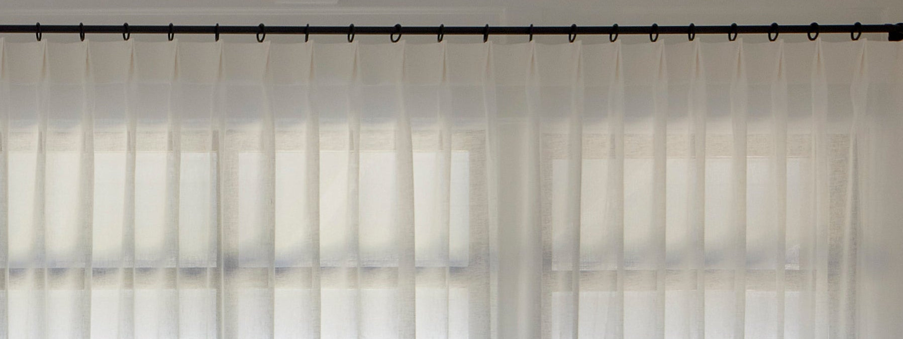 A living room with custom Everhem pleated drapery.