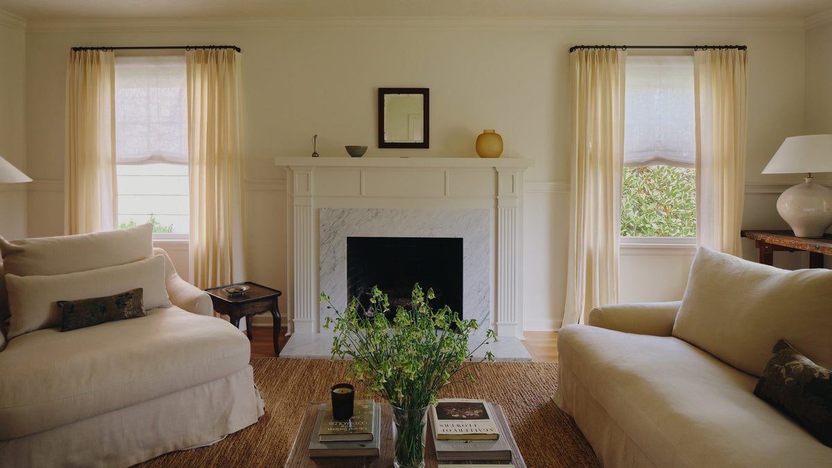 Molly Kidd seated in a softly lit room with Everhem window treatments.