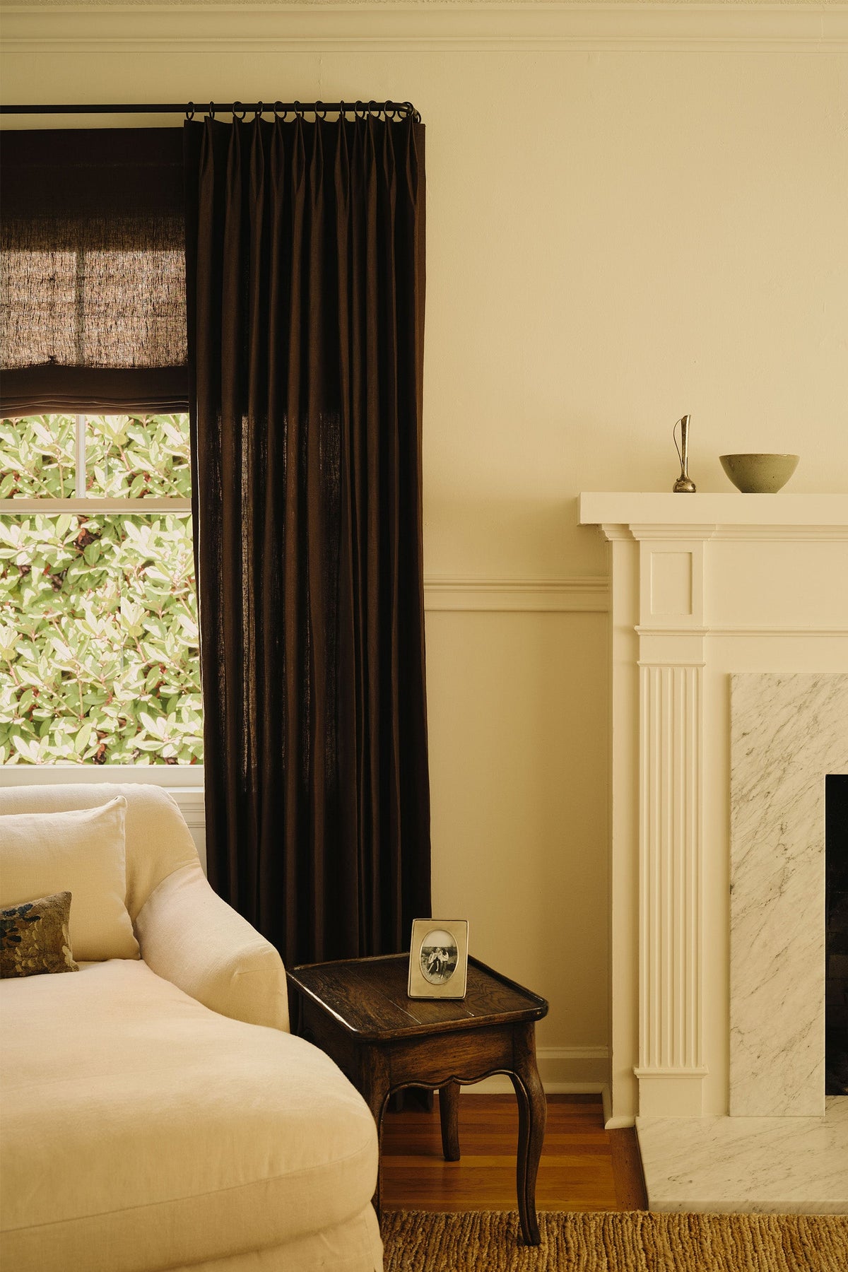 Layered sheer and solid drapery in a softly lit room.