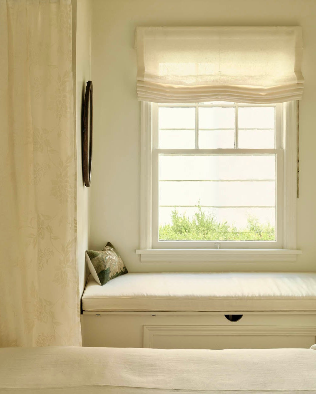 Layered sheer and solid drapery in a softly lit room.