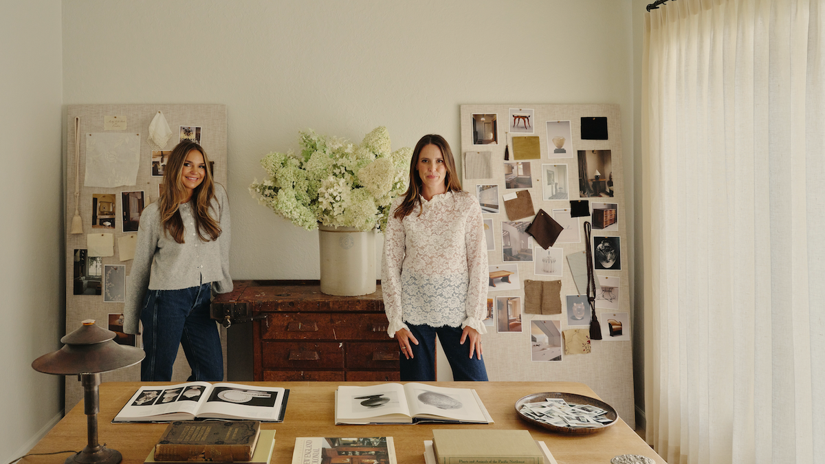 Molly Kidd and Everhem collaborators standing in a studio with mood boards and sheer window treatments.