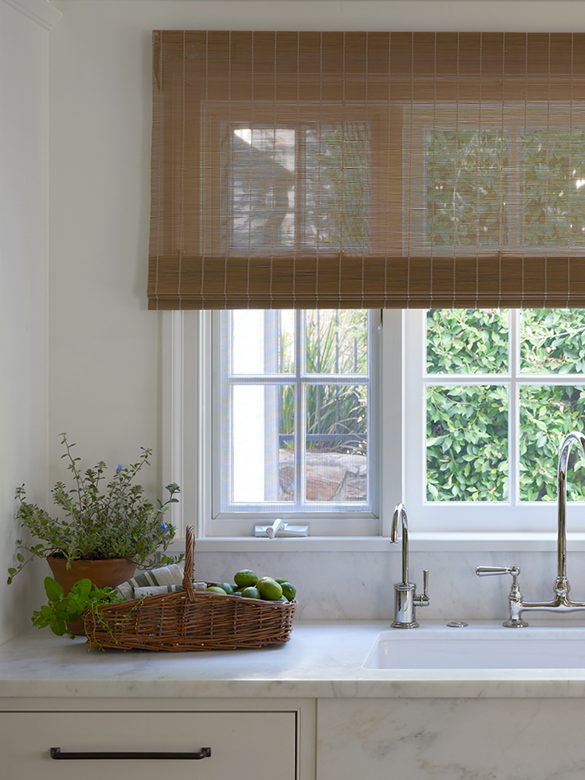 Kitchen window with oak matchstick shade.