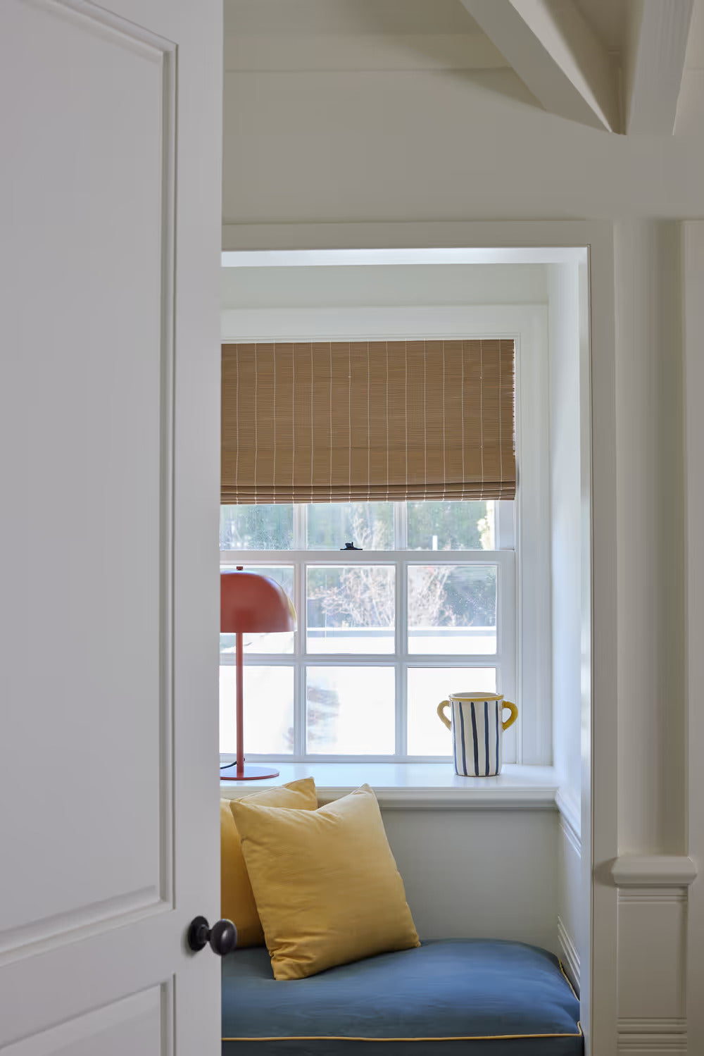 Bay window dining nook with Oak matchstick shades
